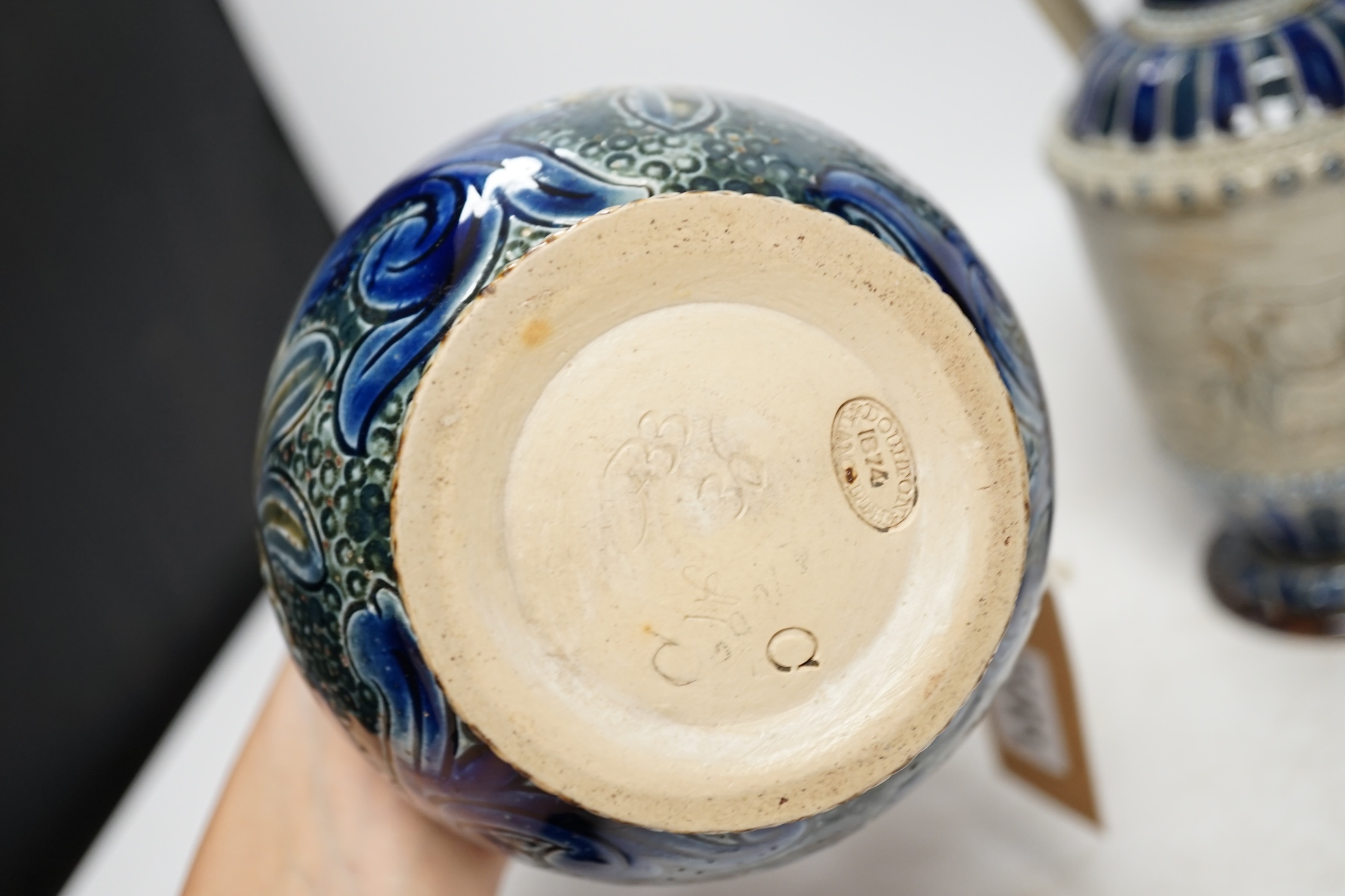 A Hannah Barlow for Doulton ‘geese and donkey’ jug, another jug dated 1874 and a small Royal Doulton vase, largest 24cm high. Condition - good